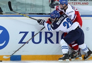ZUG, SWITZERLAND - APRIL 16: Finland's Julius Mattila #28 and the Czech Republic's Jan Dufek #27 battle for the puck along the boards during preliminary round action at the 2015 IIHF Ice Hockey U18 World Championship. (Photo by Francois Laplante/HHOF-IIHF Images)
